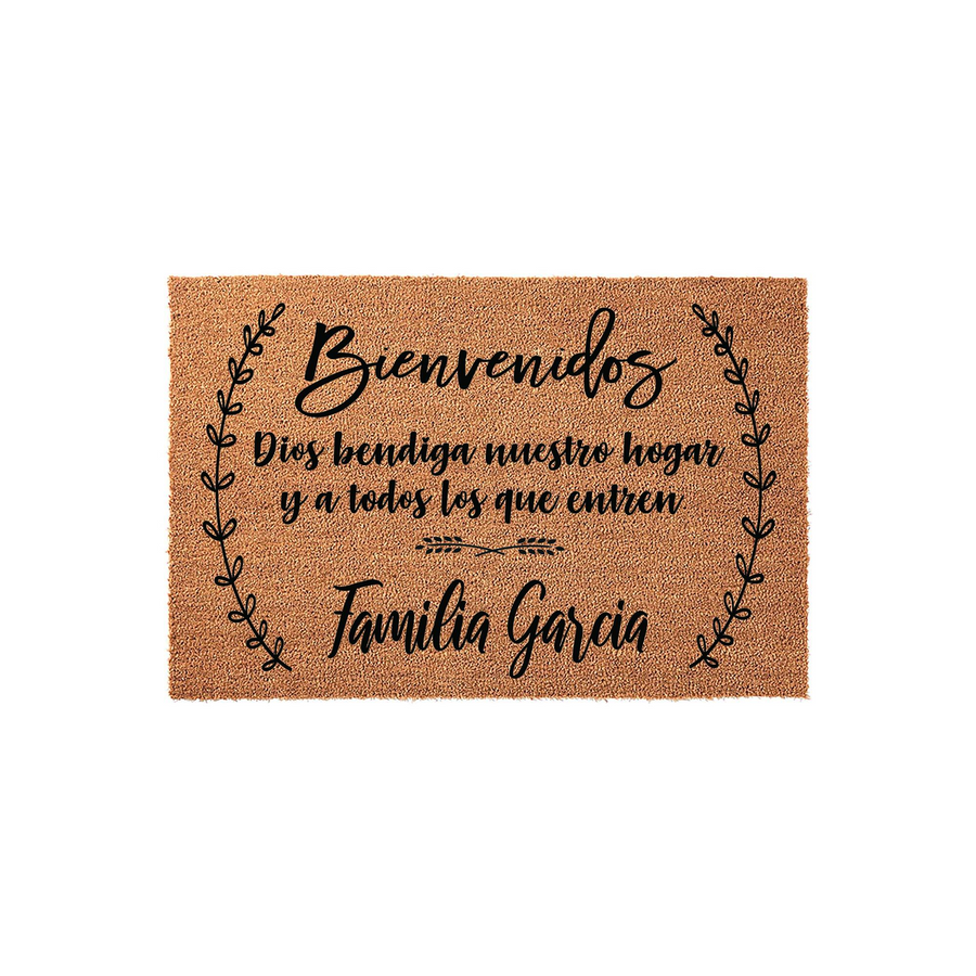 Personalized Spanish Welcome Doormat featuring a natural coir texture with black script text that reads Bienvenidos and includes a custom family name, framed by elegant leaf branches on a clean white studio background for a home