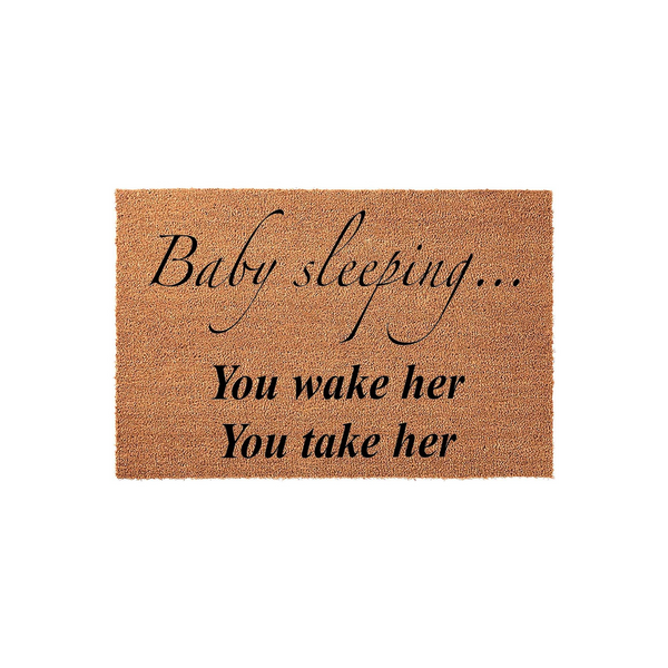 Baby Sleeping Doormat made of natural coir fiber, featuring black printed text that reads Baby sleeping, You wake her, You take her, designed as a humorous front porch sign for new parents to keep visitors quiet at the front door.