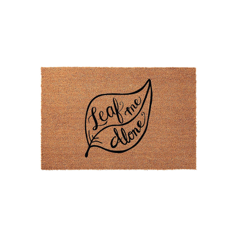 Leaf Me Alone funny coir doormat featuring a large black leaf graphic with elegant cursive lettering centered on a natural brown coconut fiber background, creating a humorous and welcoming entrance for any home or apartment porch.