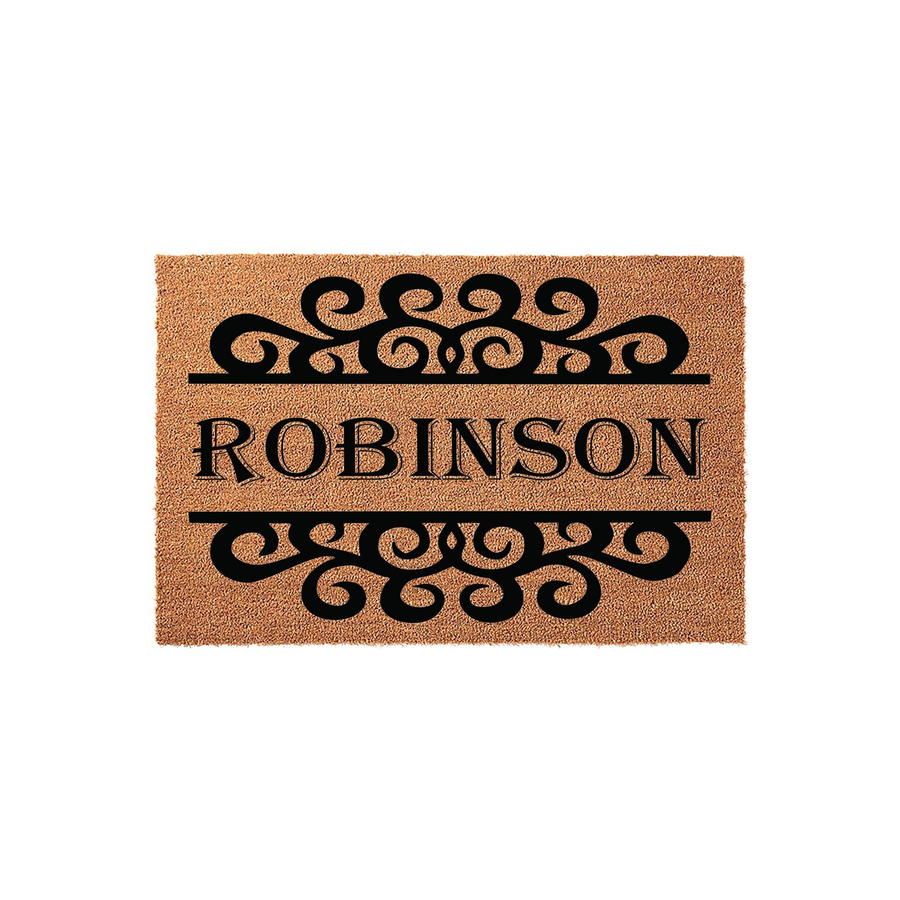 Personalized family name coir doormat featuring a classic black scrollwork design above and below the custom text, set against a natural tan coconut fiber background to provide a welcoming entrance for any home or front porch