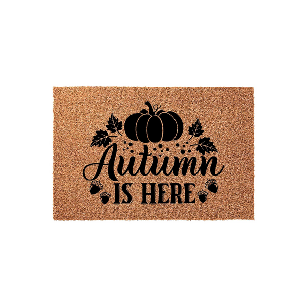Autumn Is Here coir doormat featuring a rustic pumpkin and acorn design printed in black ink on a natural tan fiber background, creating a festive seasonal entryway decor piece for your front porch during the fall harvest season.