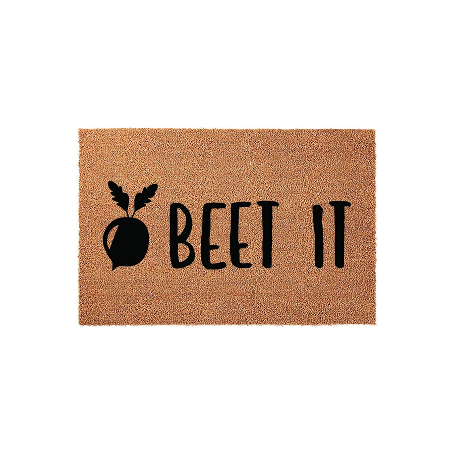 Beet It funny coir doormat featuring a black graphic of a garden beet next to the punny text, set against a natural brown coconut fiber background for a whimsical and welcoming front porch entry decor piece.