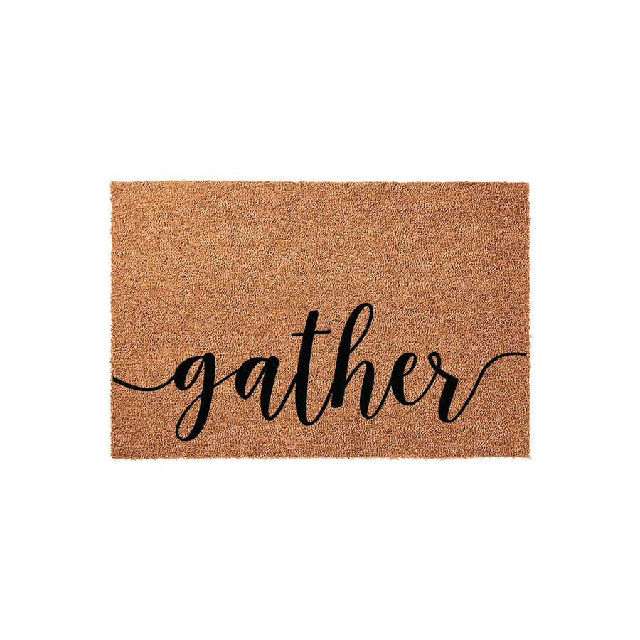 Gather coir doormat featuring a natural brown fiber texture and elegant black script lettering centered on the mat, providing a welcoming farmhouse aesthetic for your front porch entryway or home decor entrance.