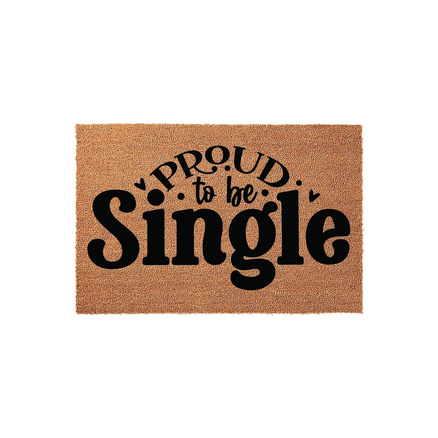 Proud to be Single coir doormat featuring bold black typography on a natural brown coconut fiber background, creating a fun and welcoming entrance mat for any apartment or home entryway that celebrates independent living.