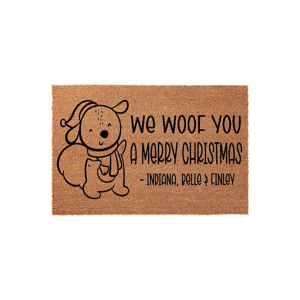 Personalized Dog Christmas Doormat featuring a cute illustrated puppy wearing a winter hat and scarf, with the text We Woof You A Merry Christmas printed on a natural brown coir fiber background for a festive holiday home