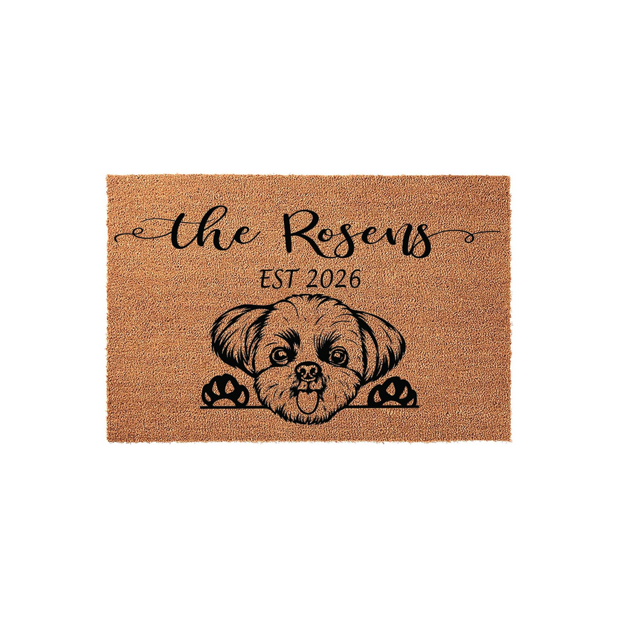 Personalized Shih Tzu doormat featuring a cute illustrated dog peeking over the bottom edge, printed on a natural coir fiber mat with custom family name text and established year details for a welcoming front porch entrance decor.