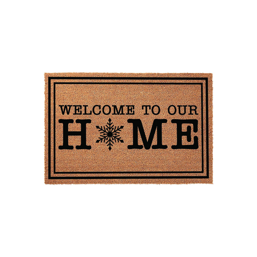 Winter Snowflake Welcome To Our Home Doormat featuring a natural coir texture with a black border and bold lettering, where the letter O is replaced by a detailed snowflake design for a festive seasonal entryway decor piece.