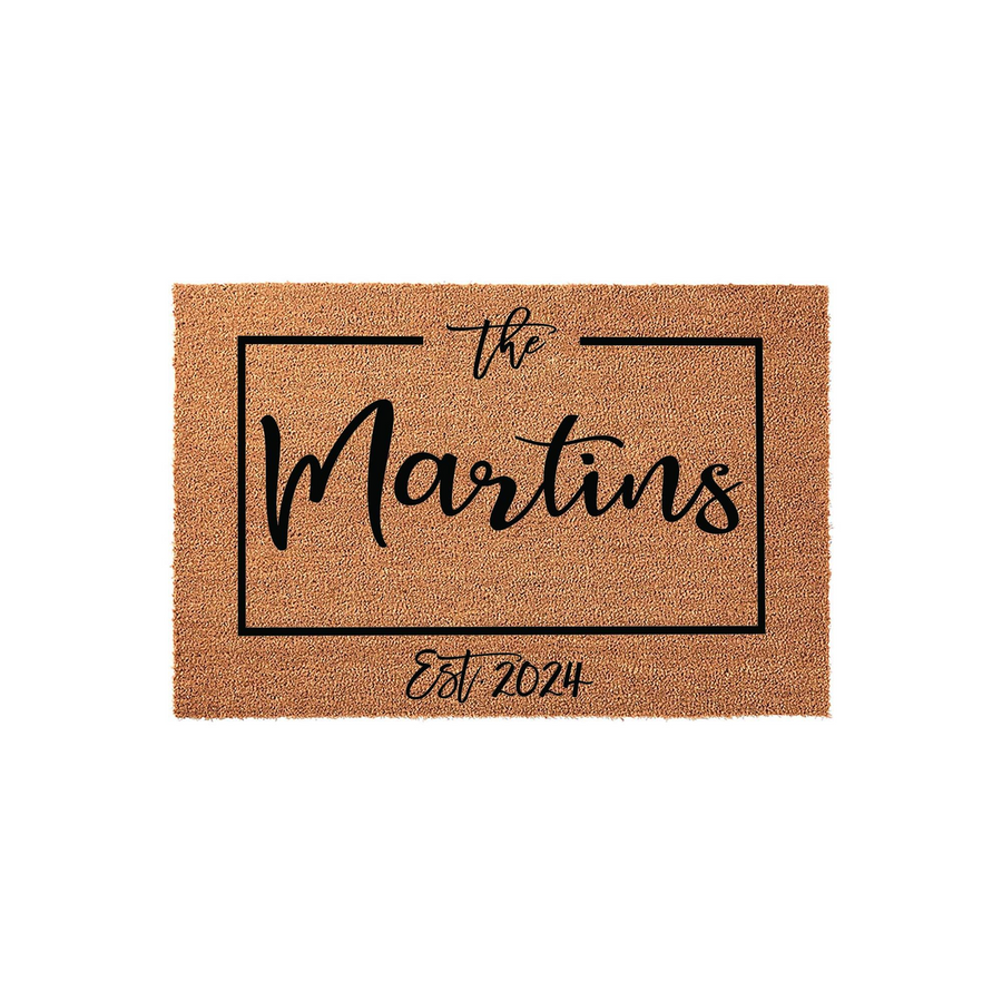 Personalized family name coir doormat featuring a clean rectangular border design with elegant black script text, providing a welcoming entrance piece for a home that highlights the established year on a natural tan fiber