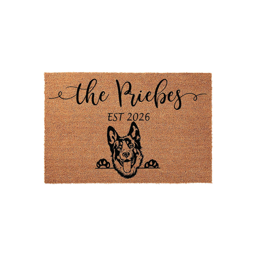 Personalized German Shepherd doormat featuring a natural coir texture with a black printed illustration of a dog peeking over a line, customized with a family name and established year for a welcoming home entrance decor piece.
