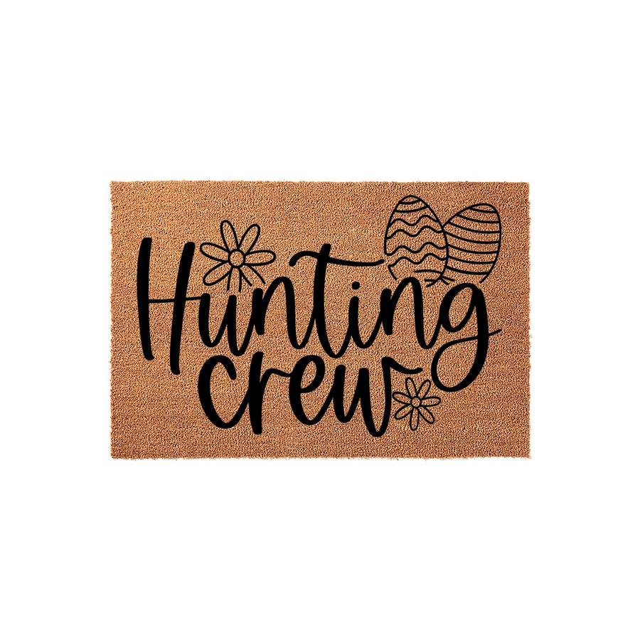 Hunting Crew Easter doormat featuring natural coir fibers with black text, decorative flower accents, and patterned egg illustrations, creating a festive seasonal welcome for your front porch entryway during the spring holiday