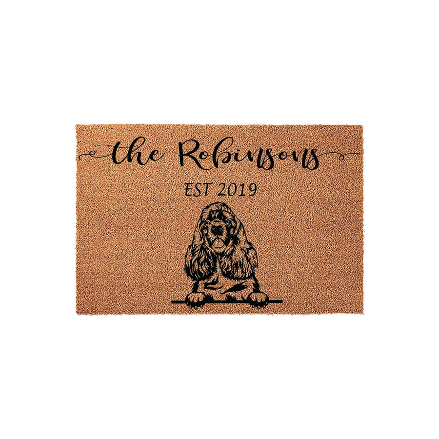 Personalized Cocker Spaniel doormat featuring a natural coir texture with a black illustration of a dog and custom family name text, making a welcoming addition to any front porch entryway for pet lovers and new homeowners alike.