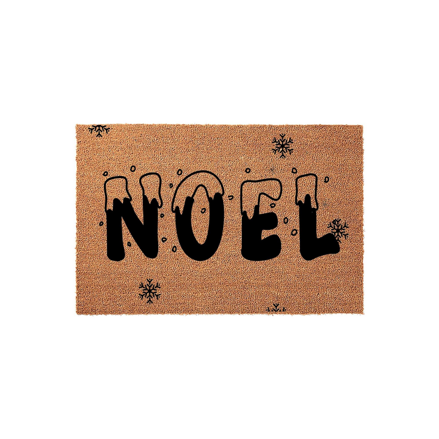 Noel Christmas doormat made of natural coir fiber, featuring bold black lettering with a snowy drip effect and small snowflake accents scattered across the rectangular mat against a clean white studio background.