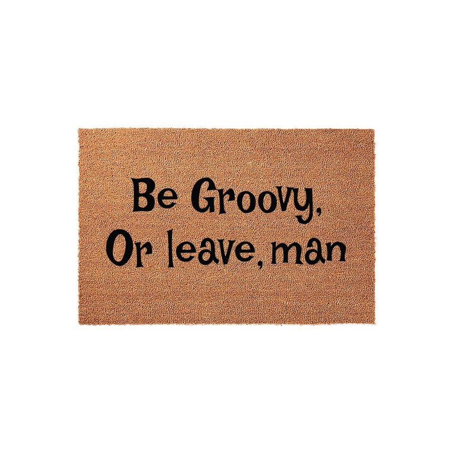 Be Groovy Or Leave Man Coir Doormat featuring a natural brown fiber texture and bold black lettering that adds a fun retro vibe to your front porch entryway, making it a welcoming and humorous addition to any home decor style.