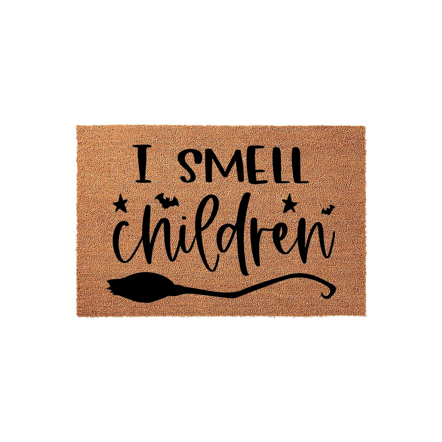 I Smell Children Halloween Doormat featuring a natural coir fiber texture with black text and a witch broom graphic, perfect for seasonal porch decor that adds a fun and spooky touch to your home entrance during the fall holiday