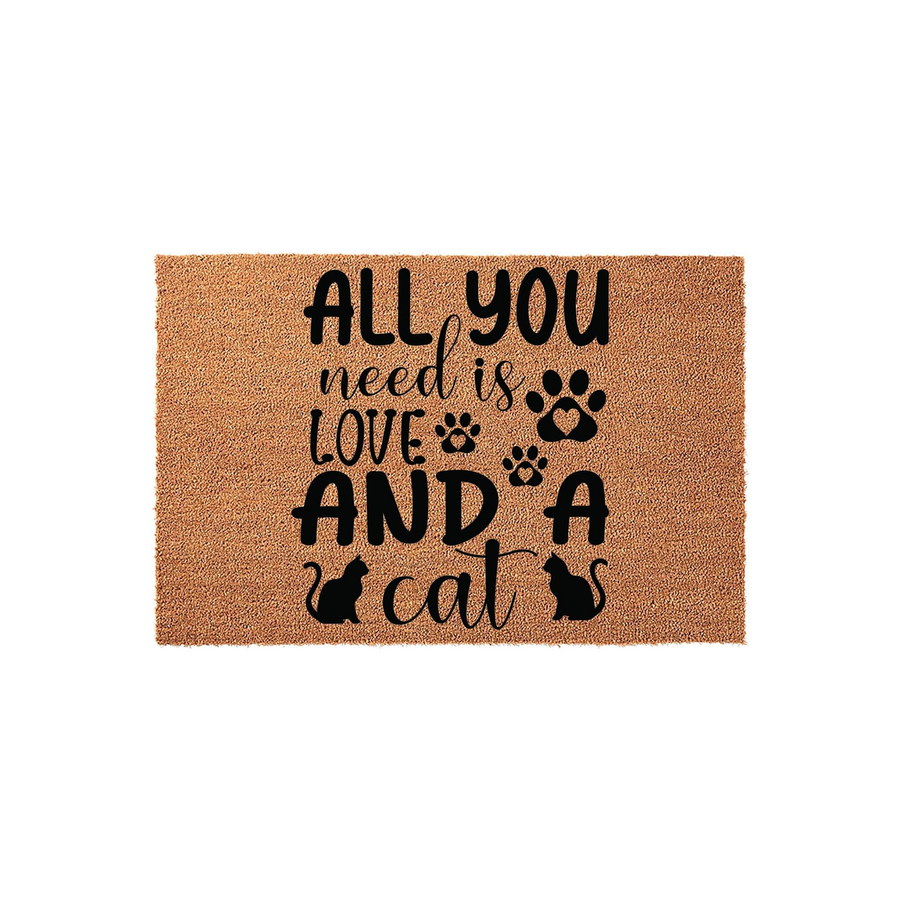 Cat Lover Coir Doormat featuring the text All You Need Is Love And A Cat in black lettering, accented with paw prints and cat silhouettes on a natural tan textured fiber background, perfect for a pet owner's front porch entryway