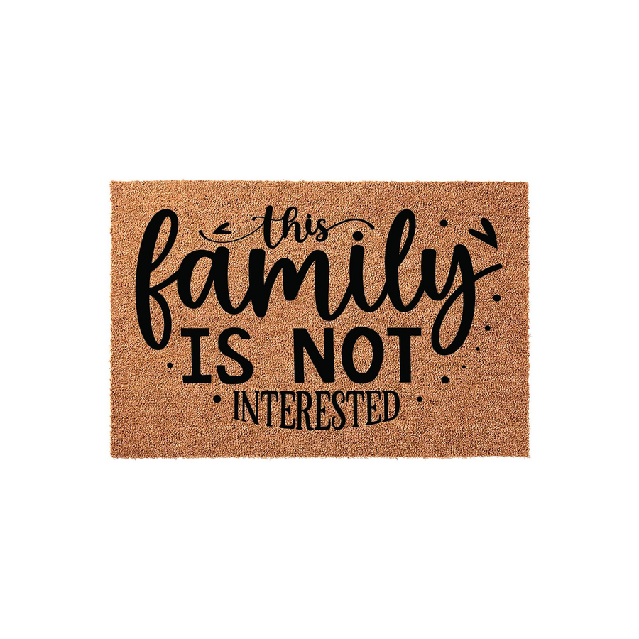 Funny Family Is Not Interested doormat made of natural coir fiber with a clean white background, featuring bold black typography that humorously warns solicitors to stay away from the front porch of your home with a playful