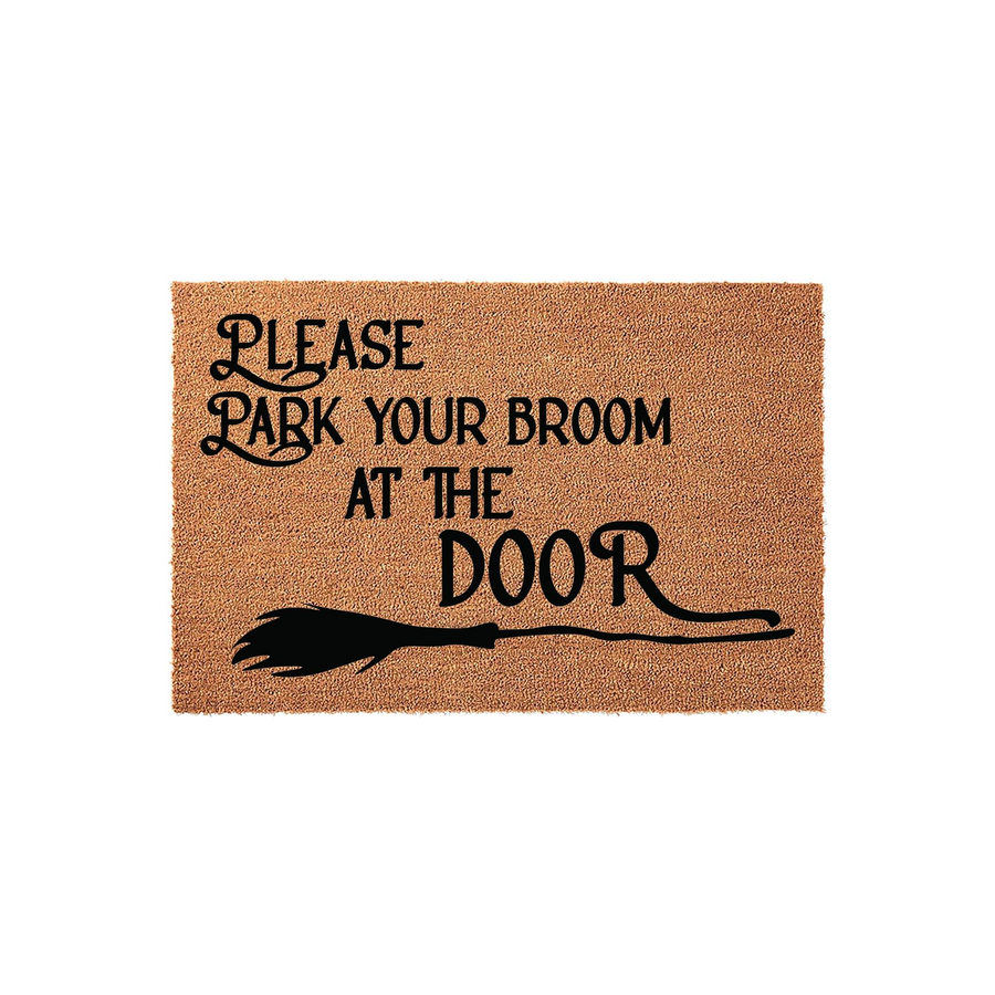Funny Halloween doormat made of natural coir fiber, featuring the text Please Park Your Broom At The Door in black script and a witch broom graphic, perfect for adding a spooky and whimsical touch to your front porch entryway