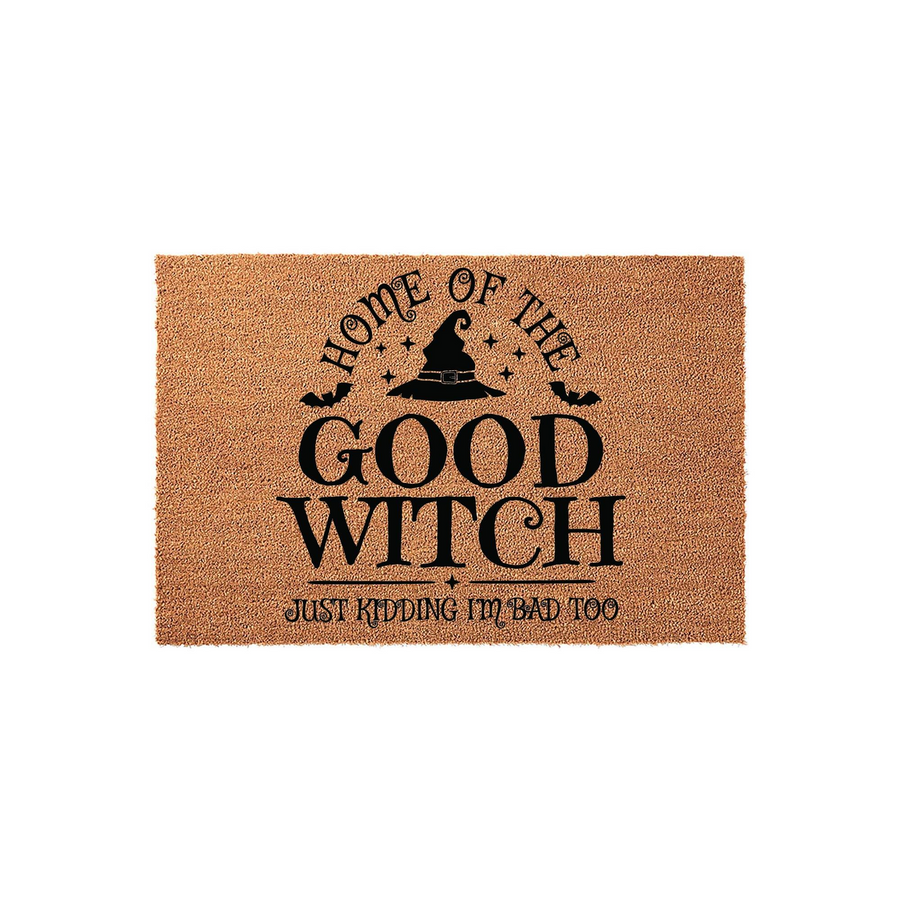 Funny Good Witch Halloween Doormat featuring a black witch hat graphic and the text Home of the Good Witch, Just Kidding I am Bad Too, printed on a natural brown coir fiber mat against a clean white studio background for seasonal