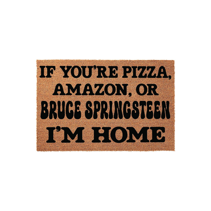 Funny Welcome Doormat featuring bold black text on a natural coir fiber background that reads If You Are Pizza, Amazon, Or Bruce Springsteen I Am Home, making it a humorous front porch decor piece for music fans and home delivery