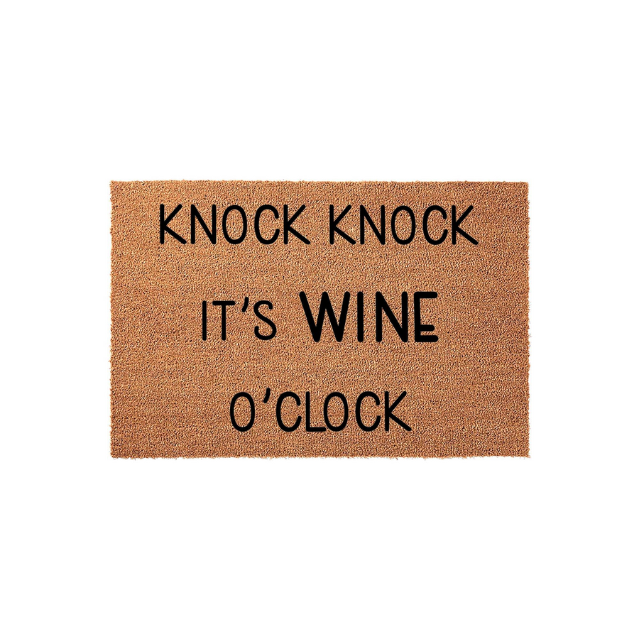 Knock Knock It's Wine O'Clock funny doormat featuring bold black text printed on a natural tan coir fiber mat, providing a humorous and welcoming touch to any front porch or entryway decor for wine lovers.