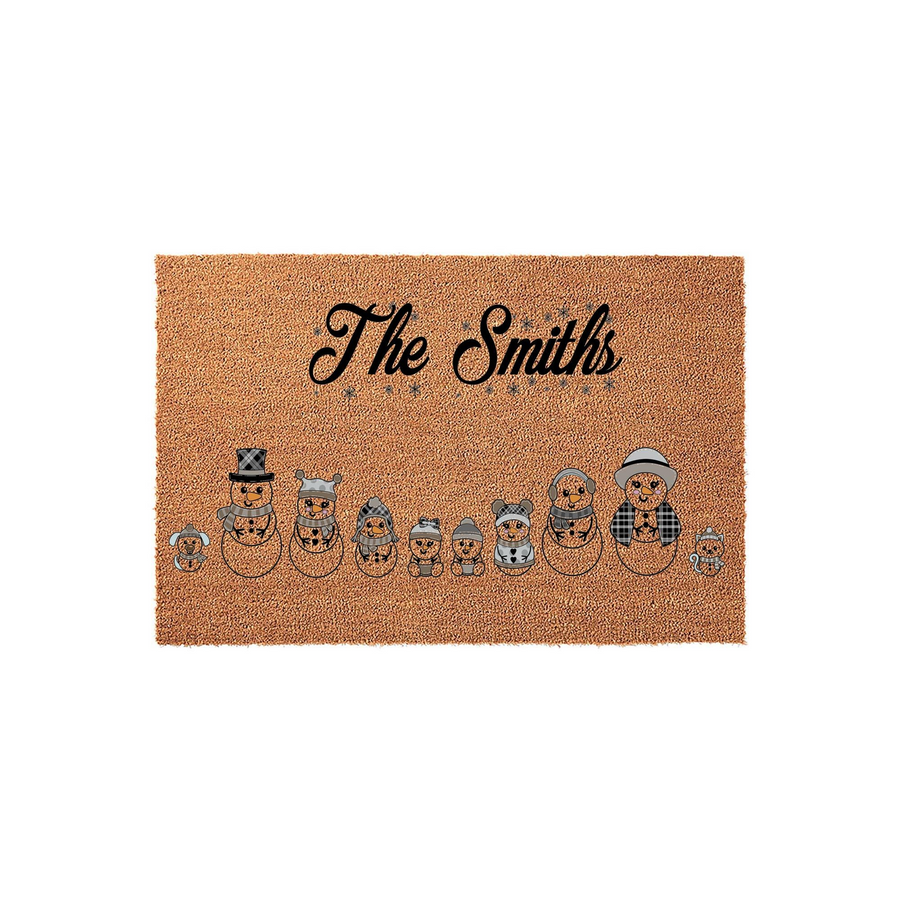 Personalized family snowman doormat featuring a line of cute illustrated snowmen in winter hats and scarves, with a custom family name printed in elegant black script above the festive holiday characters on a natural coir fiber