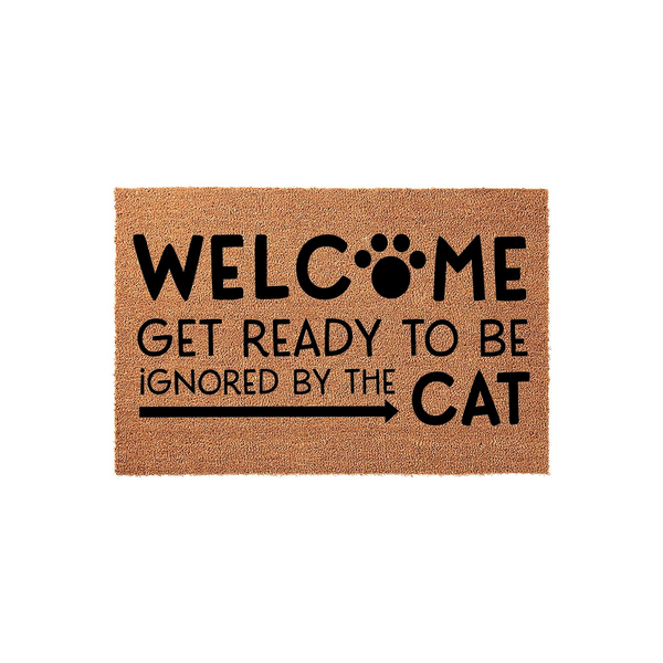 Funny Cat Welcome Doormat featuring a natural coir texture with bold black text that reads Welcome Get Ready To Be Ignored By The Cat, complete with a paw print design and an arrow pointing toward the word cat on a plain white