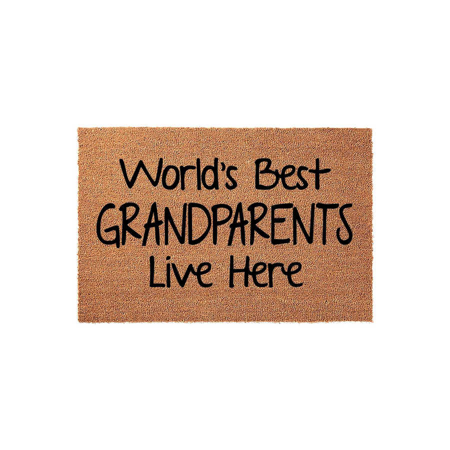 World's Best Grandparents Live Here coir doormat features bold black lettering on a natural tan fiber background, creating a welcoming entryway accent that celebrates a loving home for any grandmother or grandfather.