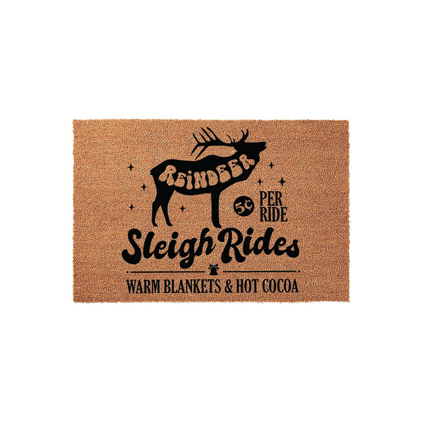 Reindeer Sleigh Rides Christmas doormat featuring a black silhouette of a reindeer, festive stars, and text reading 50 cents per ride, warm blankets, and hot cocoa on a natural tan coir fiber background for a cozy holiday