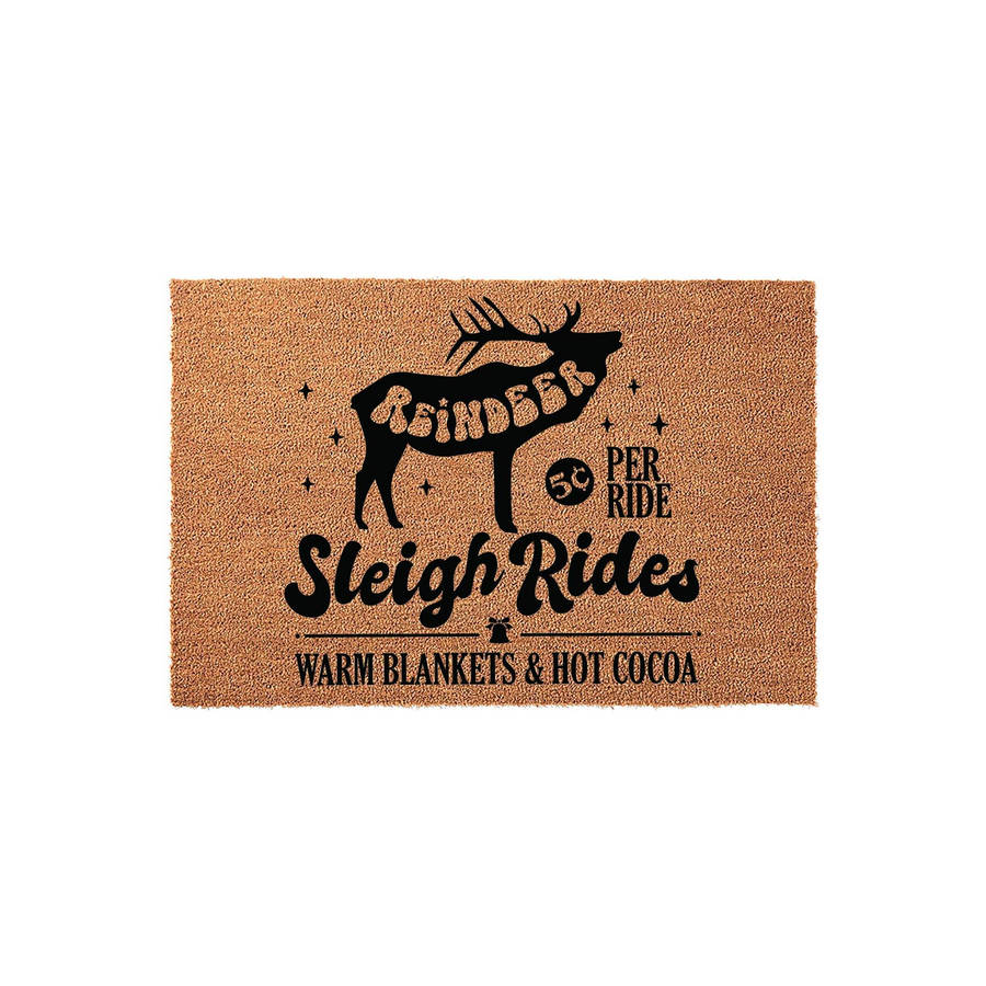 Reindeer Sleigh Rides Christmas doormat featuring a black silhouette of a reindeer, festive stars, and text reading 50 cents per ride, warm blankets, and hot cocoa on a natural tan coir fiber background for a cozy holiday