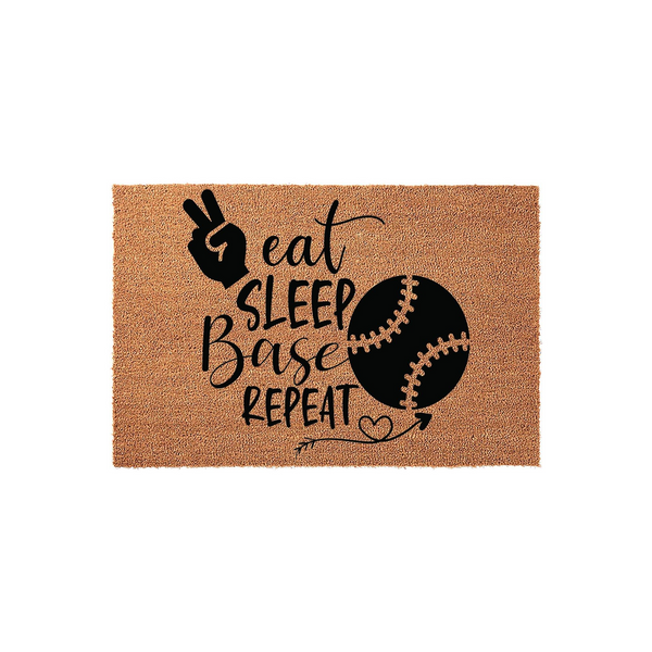 Baseball sports doormat featuring a natural coir texture with black text that reads eat sleep base repeat, accompanied by a peace sign hand gesture and a baseball graphic with a decorative arrow and heart accent on a plain white