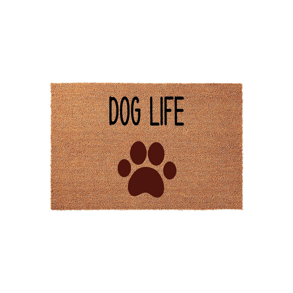 Dog Life coir doormat featuring a large dark brown paw print graphic centered below the bold black text, presented on a natural tan fiber background to add a fun and welcoming touch to any pet lover's front porch or entryway