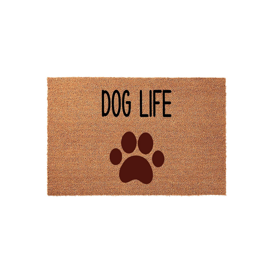 Dog Life coir doormat featuring a large dark brown paw print graphic centered below the bold black text, presented on a natural tan fiber background to add a fun and welcoming touch to any pet lover's front porch or entryway