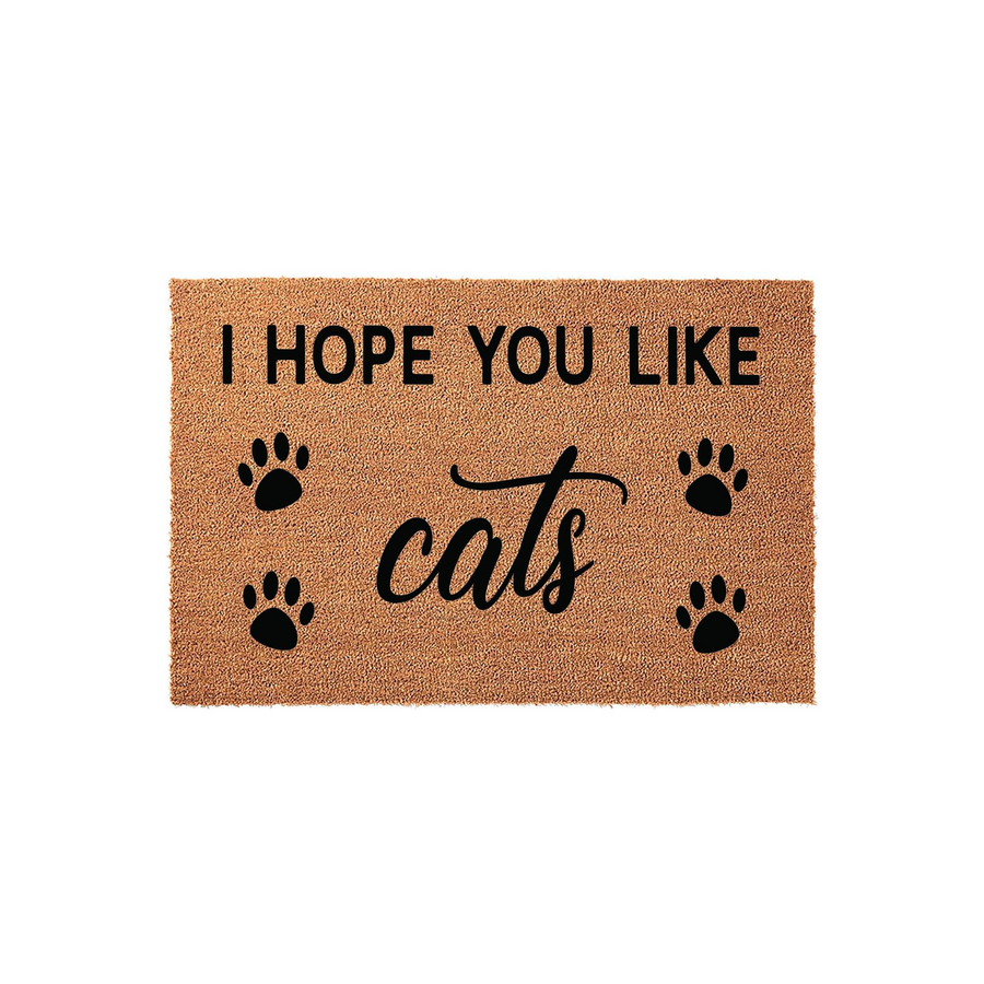 I Hope You Like Cats Coir Doormat featuring a natural tan fiber texture with bold black text and four decorative paw prints, making a fun and welcoming entrance rug for any cat lover's home decor on a plain white studio