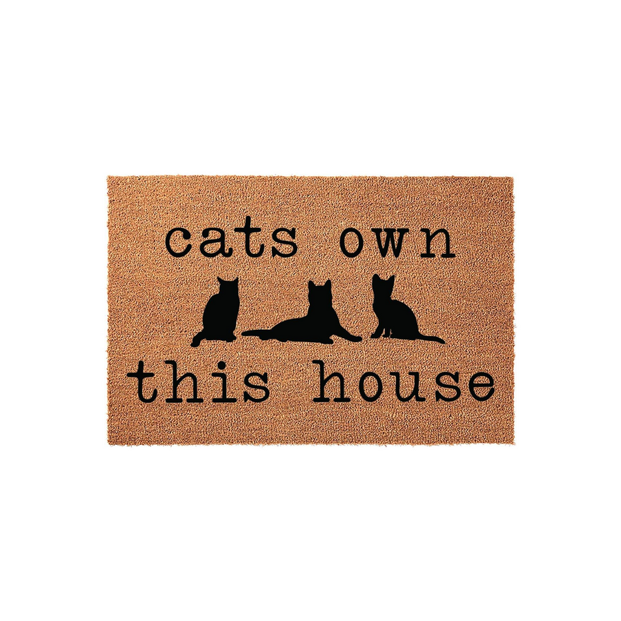 Cats Own This House coir doormat featuring a natural brown fiber texture and black silhouette graphics of three cats, making it a fun and welcoming entrance rug for any cat lover looking to decorate their front porch or entryway