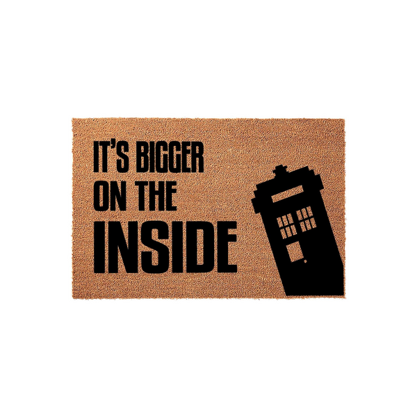 Sci-fi themed doormat featuring a natural coir texture with the black printed text It's Bigger On The Inside and a silhouette of a classic police box, making a fun entrance decor piece for any fan of time-traveling television