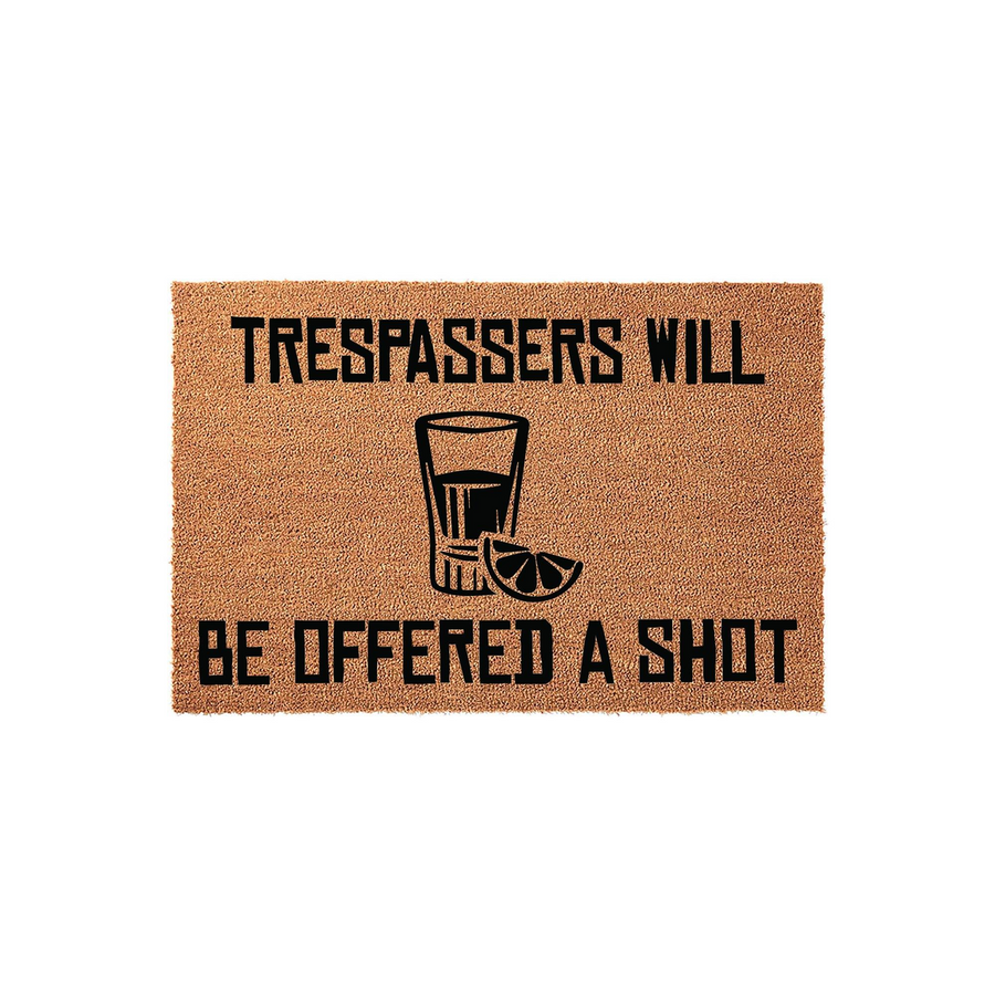 Funny Trespassers Will Be Offered A Shot doormat made of natural coir fiber, featuring bold black text and a graphic illustration of a shot glass with a lime wedge centered on a plain white background for a humorous home entryway.
