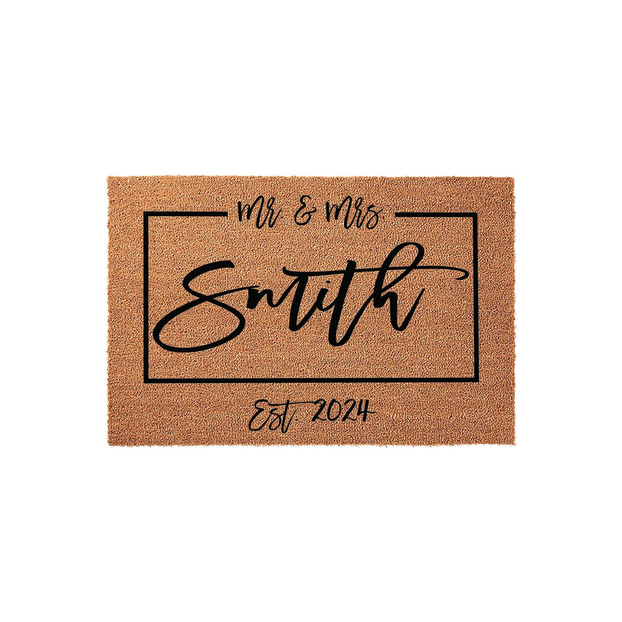 Personalized Mr and Mrs coir doormat featuring a rectangular black border, elegant script lettering for the family name, and the established year 2024 printed on a natural brown textured fiber background for a classic wedding