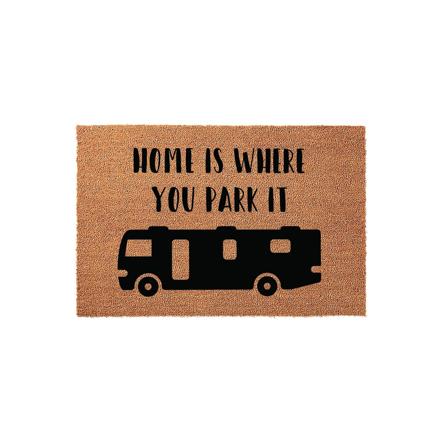 Home Is Where You Park It RV doormat featuring a natural coir fiber texture with a bold black silhouette of a motorhome and clean, modern lettering centered on a plain white studio background for a travel-inspired outdoor