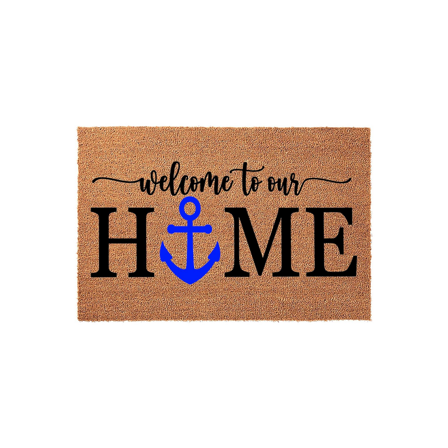 Nautical Welcome to Our Home doormat featuring a bright blue anchor replacing the letter O in the word home, printed on a natural tan coir fiber mat that provides a rustic and welcoming touch to any front porch or entryway decor.