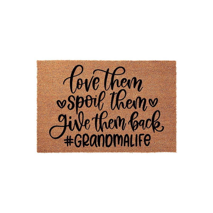 Grandma doormat made of natural coir fiber featuring black script text that reads love them spoil them give them back and the hashtag #Grandmalife, displayed against a clean white background for a festive entryway decor look.