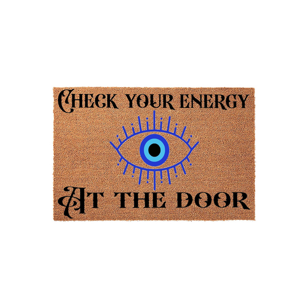 Check Your Energy At The Door coir doormat featuring a bold blue evil eye graphic centered between the text, printed on a natural tan fiber mat that adds a mystical and protective touch to any home entryway or front porch decor.