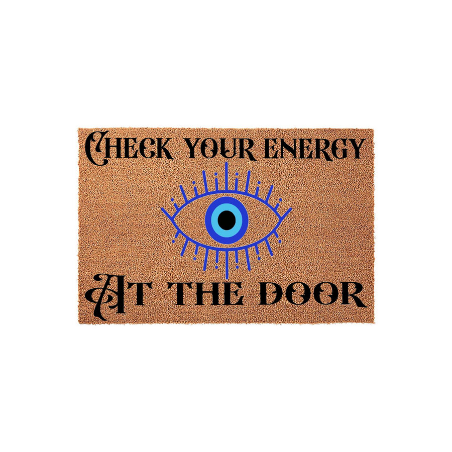Check Your Energy At The Door coir doormat featuring a bold blue evil eye graphic centered between the text, printed on a natural tan fiber mat that adds a mystical and protective touch to any home entryway or front porch decor.