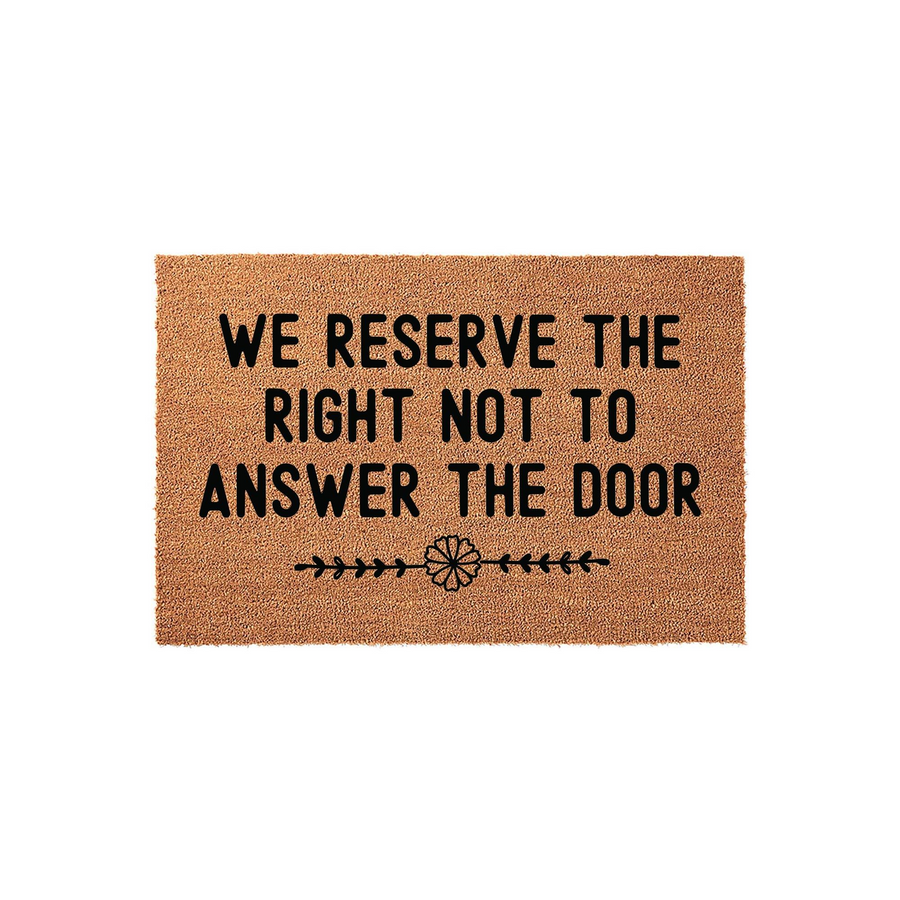 Funny doormat with the text We Reserve The Right Not To Answer The Door printed in bold black letters on a natural brown coir fiber mat, featuring a simple decorative floral line accent centered at the bottom against a plain