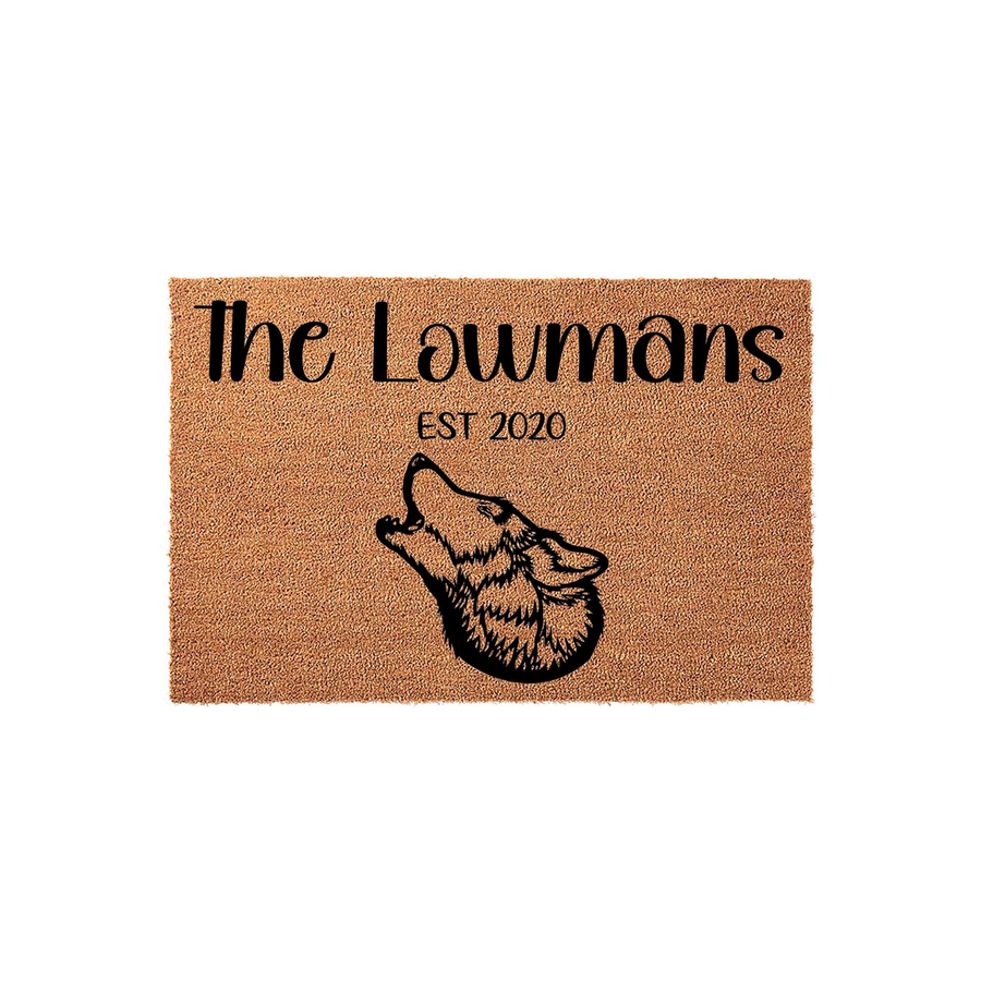 Personalized wolf family name doormat featuring a howling wolf silhouette and custom text on a natural coir fiber background, providing a rustic and welcoming entrance decor piece for any home entryway or front porch setting.