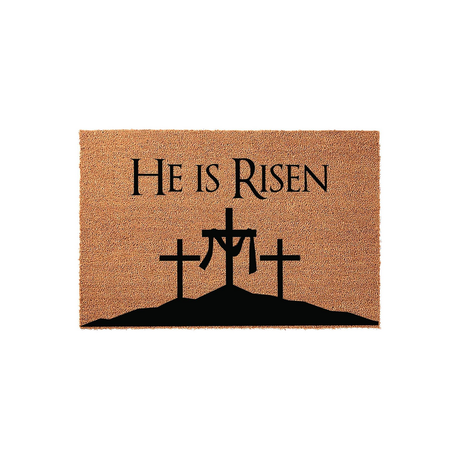 He Is Risen religious coir doormat featuring a black silhouette of three crosses on a hill, printed on a natural brown coconut fiber mat that provides a welcoming and faith-inspired entrance for your home during the Easter season.