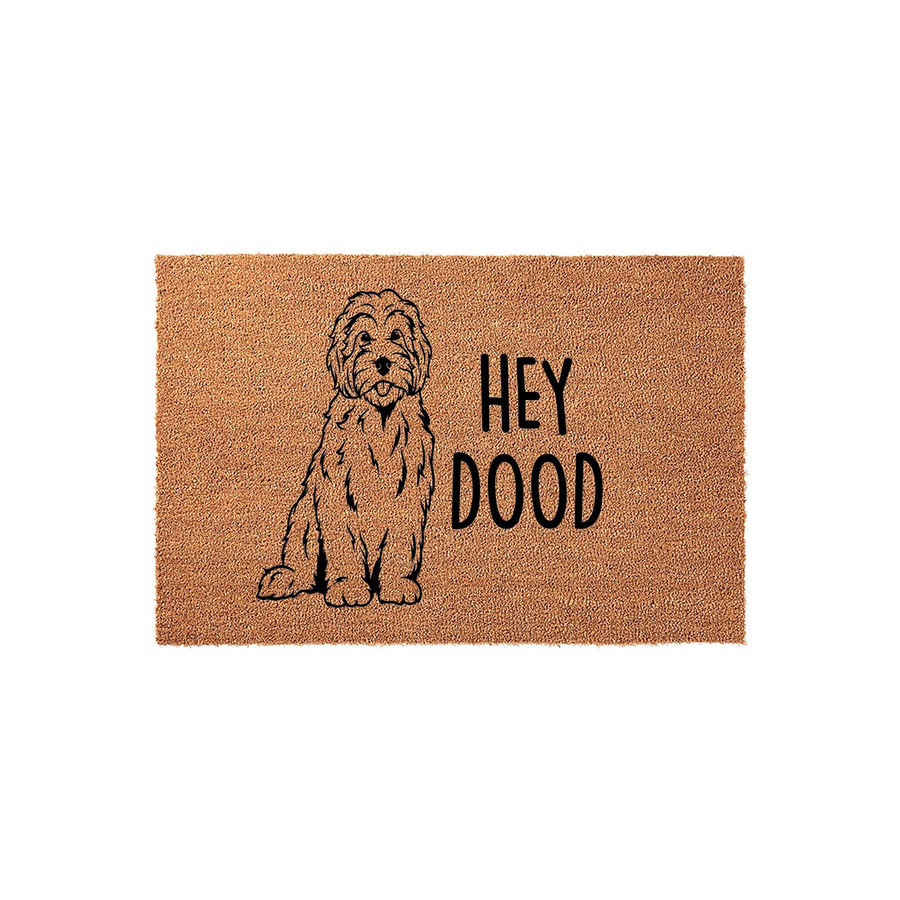 Hey Dood Goldendoodle coir doormat featuring a black line art illustration of a fluffy dog sitting next to the playful text, providing a welcoming and humorous entrance decor piece for any dog lover's home on a natural tan fiber