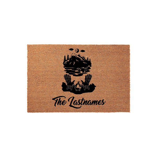 Personalized mountain lake doormat featuring a black graphic of two Adirondack chairs by a campfire with a mountain landscape, customized with a family name in elegant script on a natural tan coir fiber background for a rustic