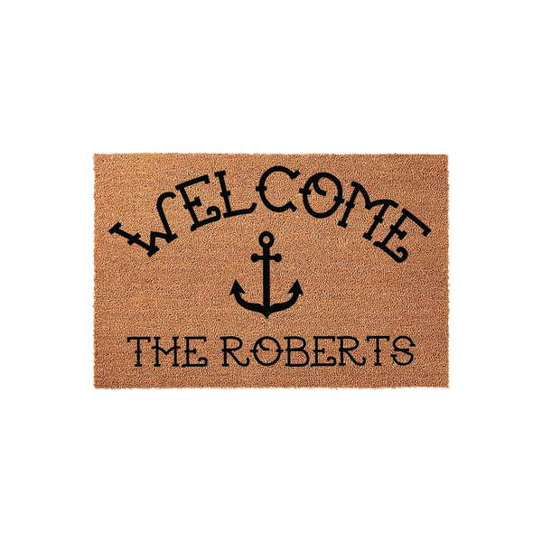 Personalized nautical anchor welcome doormat featuring a natural coir texture with black printed text that says Welcome and includes a custom family name, creating a coastal home decor accent for your front porch or entryway.