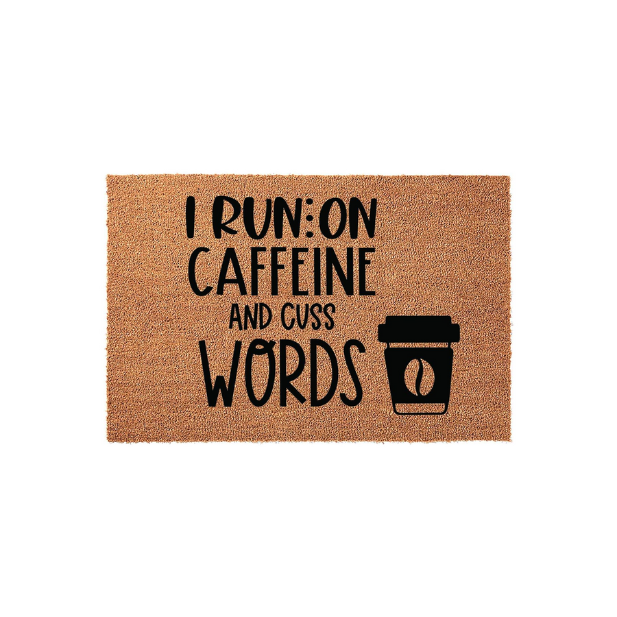 Funny Coffee Themed Coir Doormat featuring the text I Run On Caffeine And Cuss Words in bold black lettering, accompanied by a simple coffee cup icon on a natural brown textured fiber background for a humorous entryway decor