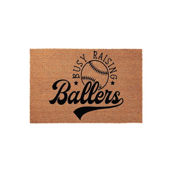 Busy Raising Ballers baseball doormat made of natural coir fiber, featuring a black printed design of a baseball and bold sports-themed typography on a rectangular mat, perfect for a baseball mom or sports fan front porch